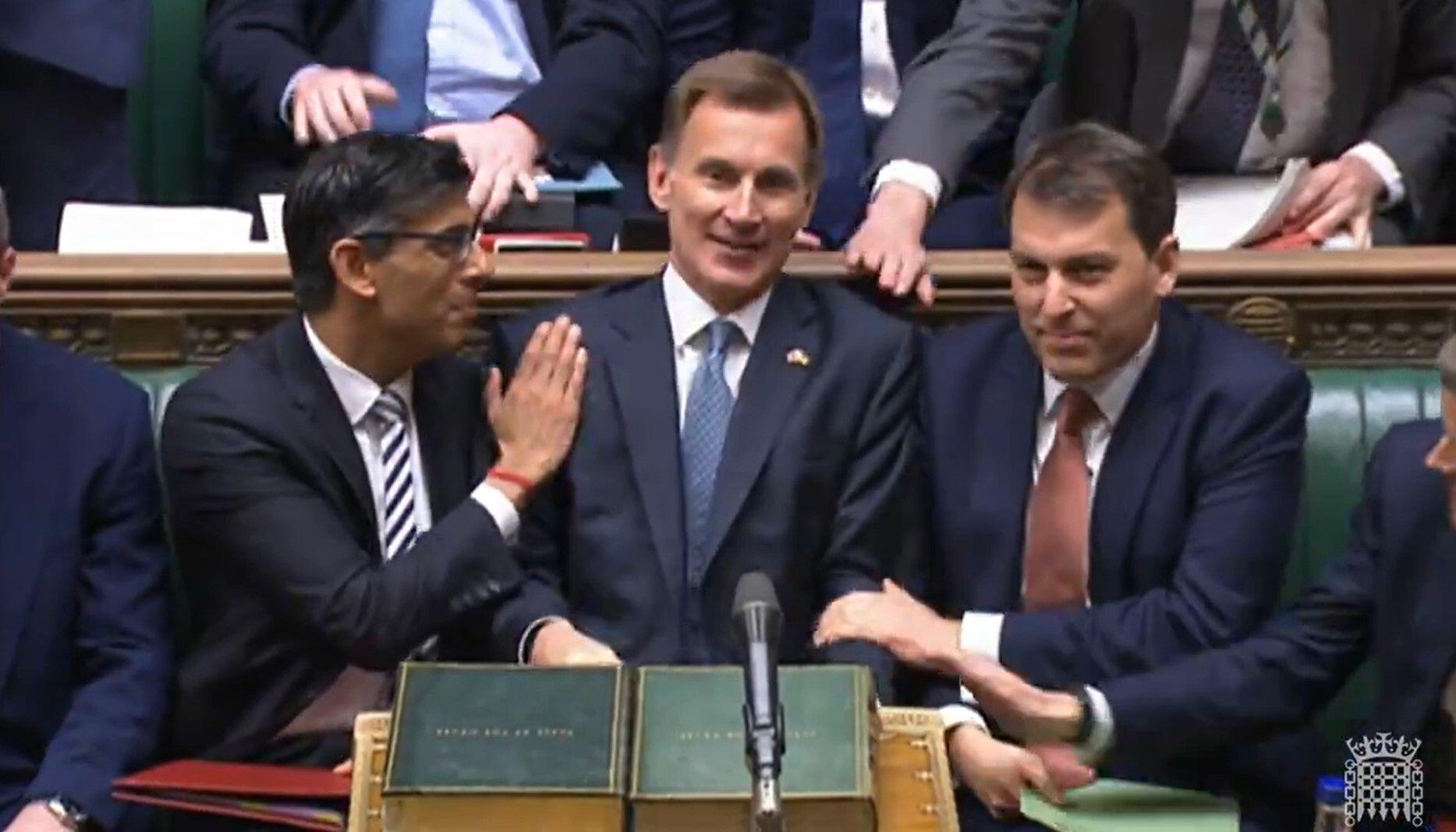 Jeremy Hunt sitting with Rishi Sunak