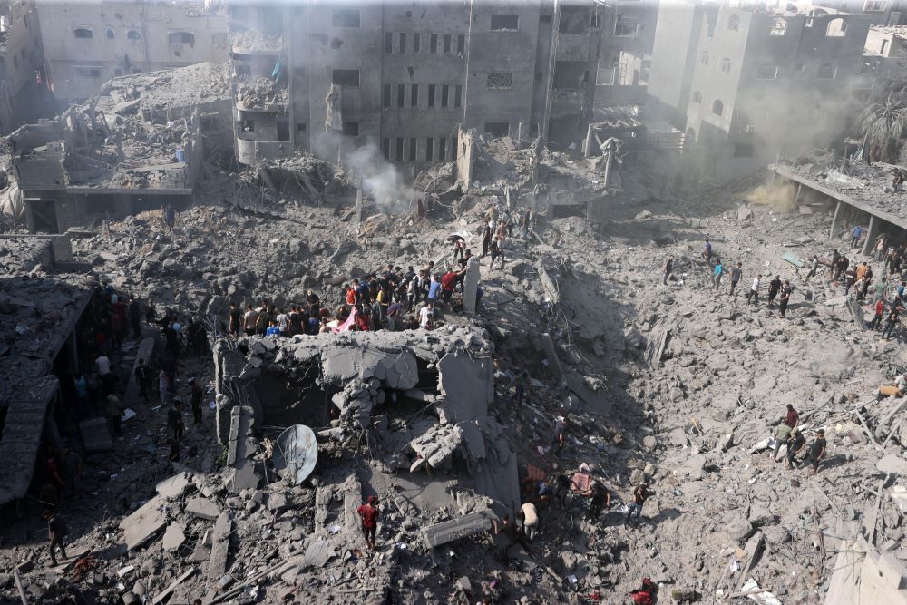  People conduct rescue work among the rubble of buildings destroyed in Israeli airstrikes 
