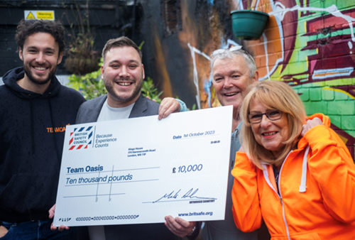 Team Oasis CEO and Founder, Paul Nilson (centre right) receives their Keep Thriving award from Matthew Stanier, Strategic Account Manager at British Safety Council (centre left), with James Nilson, Fundraiser at Team Oasis (left), and Julie Nilson (right).
