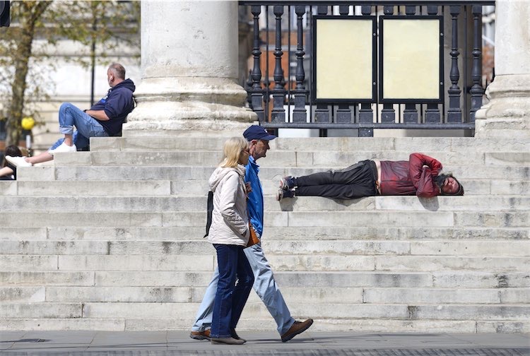 Man sleeping on steps of church