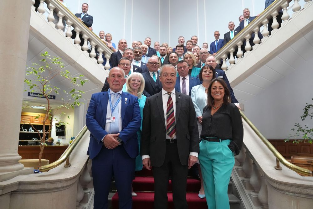 Kent Council councillors on staircase with Nigel Farage centre