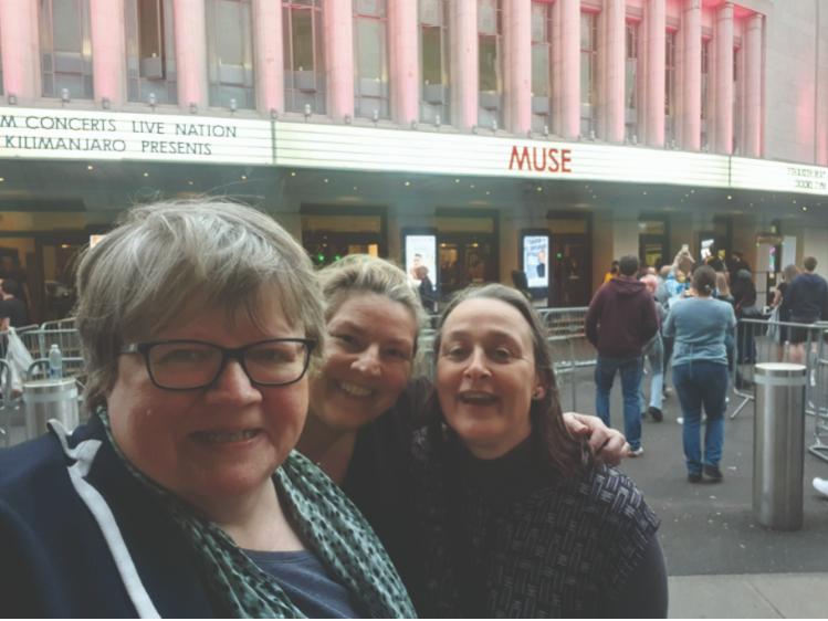 Baroness Coffey with friends at a Muse gig